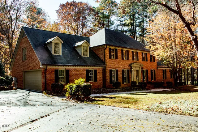 a front view of a house with a yard covered in snow