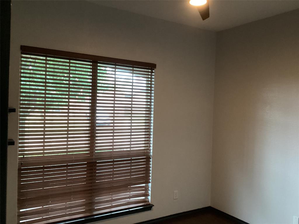 10320 Point Lobos Trail Fort Worth, TX 76177 - Photo 19 of 33 Window with wood-finish blinds, light-toned walls, dark wood-finish trim, and a ceiling fan with integrated lighting