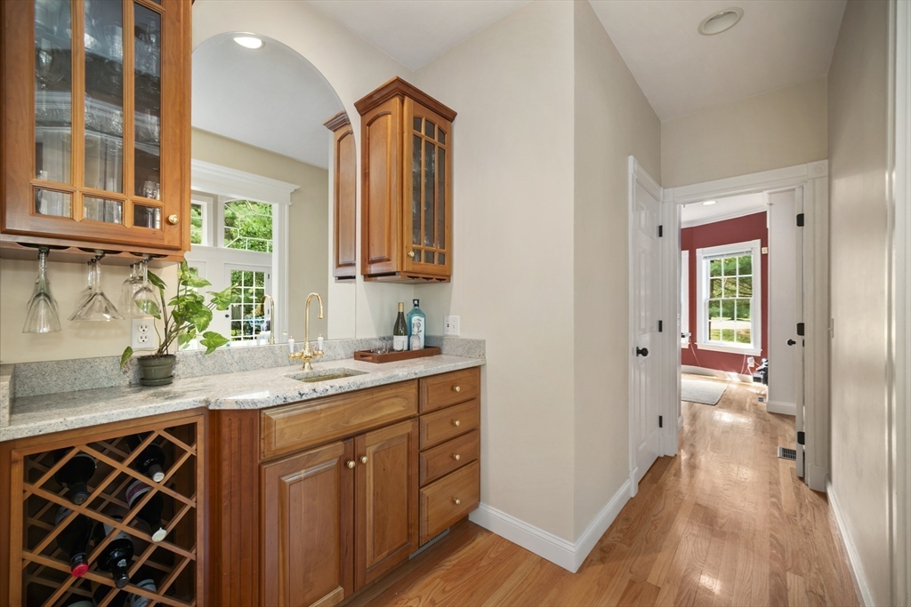 32 Bulkley Road Sudbury, MA 01776 - Photo 11 of 39 a kitchen with stainless steel appliances granite countertop a sink and a wooden cabinets