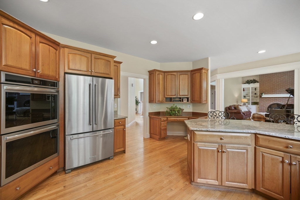 32 Bulkley Road Sudbury, MA 01776 - Photo 14 of 39 a kitchen with stainless steel appliances granite countertop a refrigerator sink and cabinets