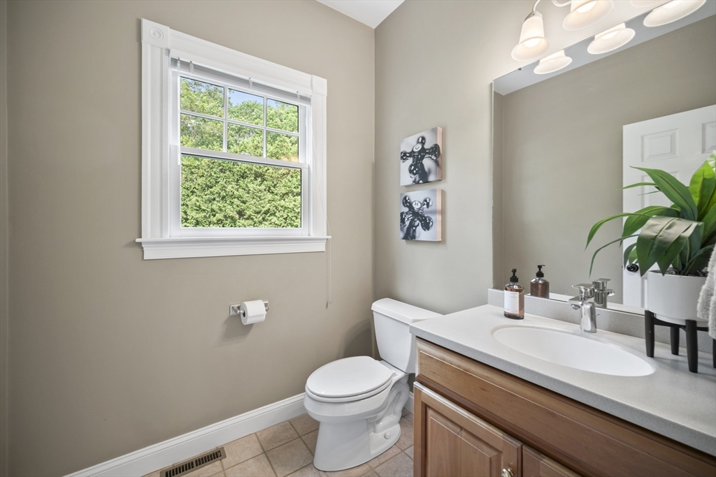 32 Bulkley Road Sudbury, MA 01776 - Photo 18 of 39 a bathroom with a granite countertop toilet sink and mirror