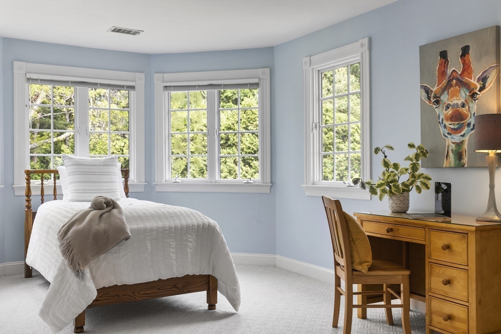 32 Bulkley Road Sudbury, MA 01776 - Photo 26 of 39 a bedroom with a bed and a table in it with window