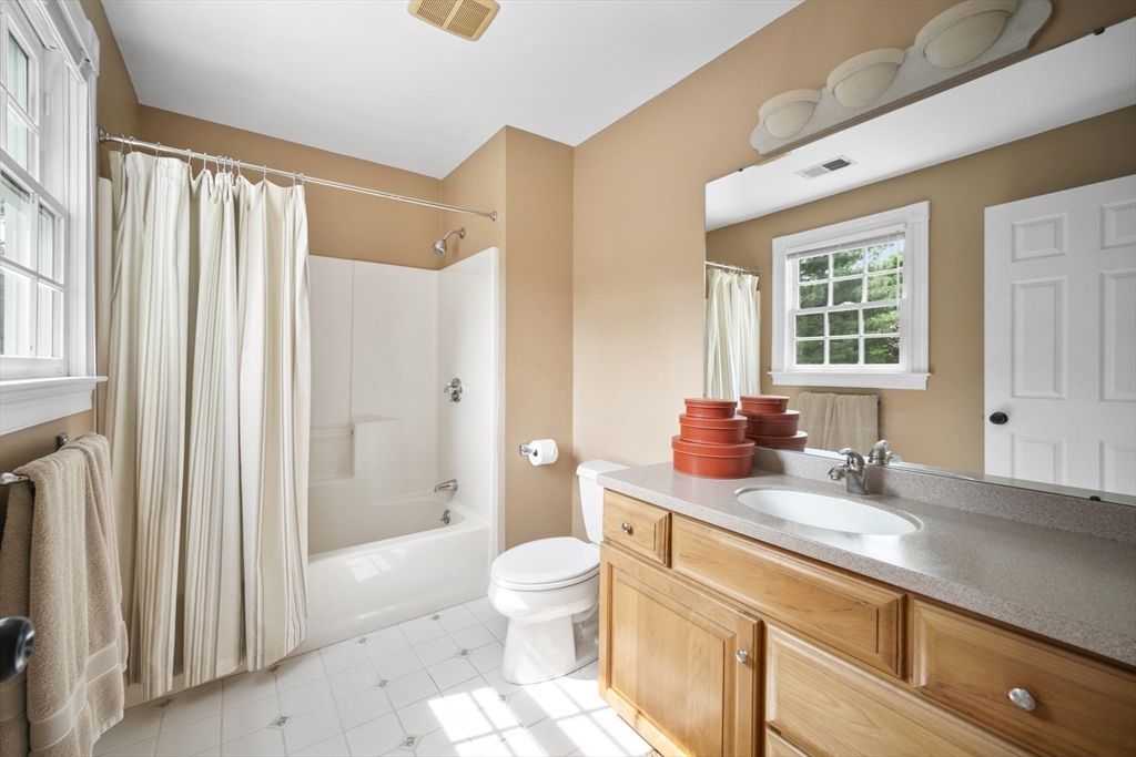 32 Bulkley Road Sudbury, MA 01776 - Photo 30 of 39 a bathroom with a granite countertop sink toilet and shower