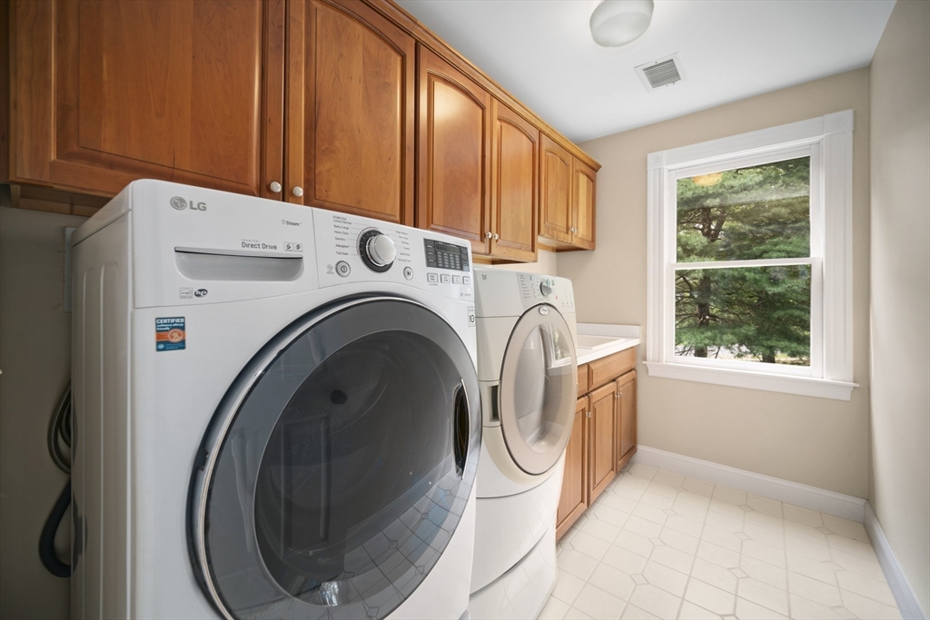 32 Bulkley Road Sudbury, MA 01776 - Photo 31 of 39 a view of a storage & utility room with washer and dryer