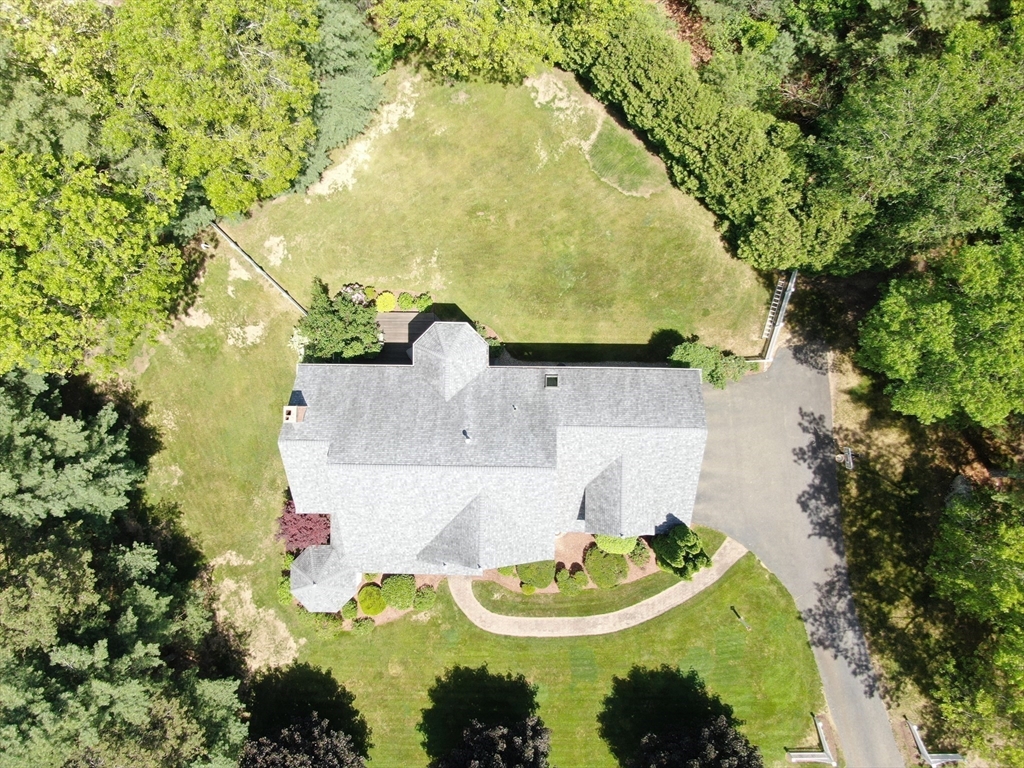 32 Bulkley Road Sudbury, MA 01776 - Photo 38 of 39 a backyard of a house with a fountain and large trees