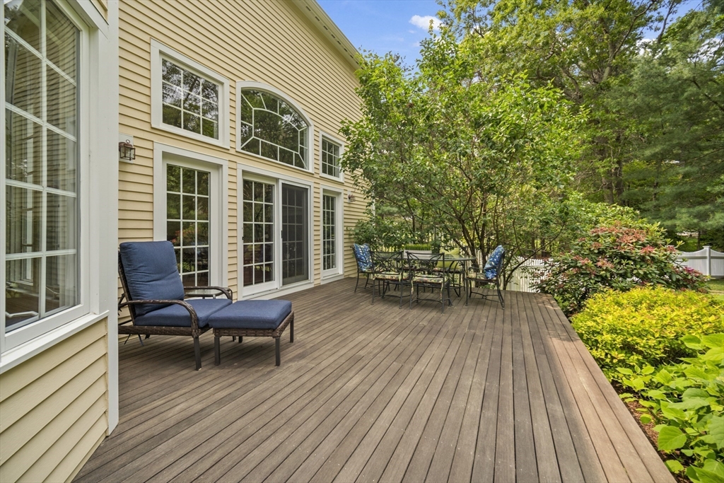32 Bulkley Road Sudbury, MA 01776 - Photo 4 of 39 a balcony with wooden floor and furniture