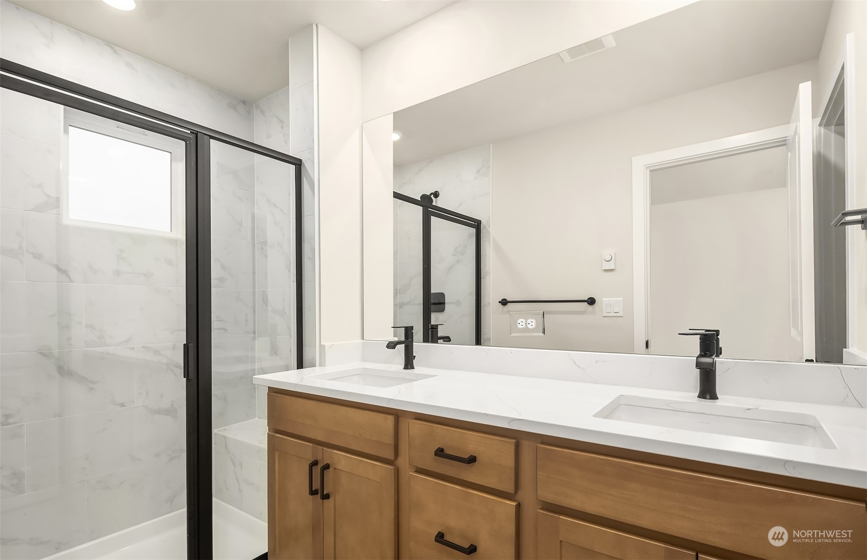 9013 Northeast 203rd Place, Unit B Bothell, WA 98021 - Photo 14 of 16 a bathroom with a double vanity sink and a mirror