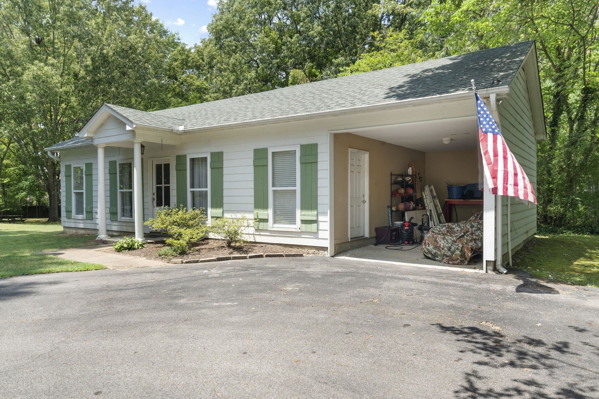 549 Peterson Lake Road Collierville, TN 38017 - Photo 28 of 34 a view of a house with backyard sitting area and garden
