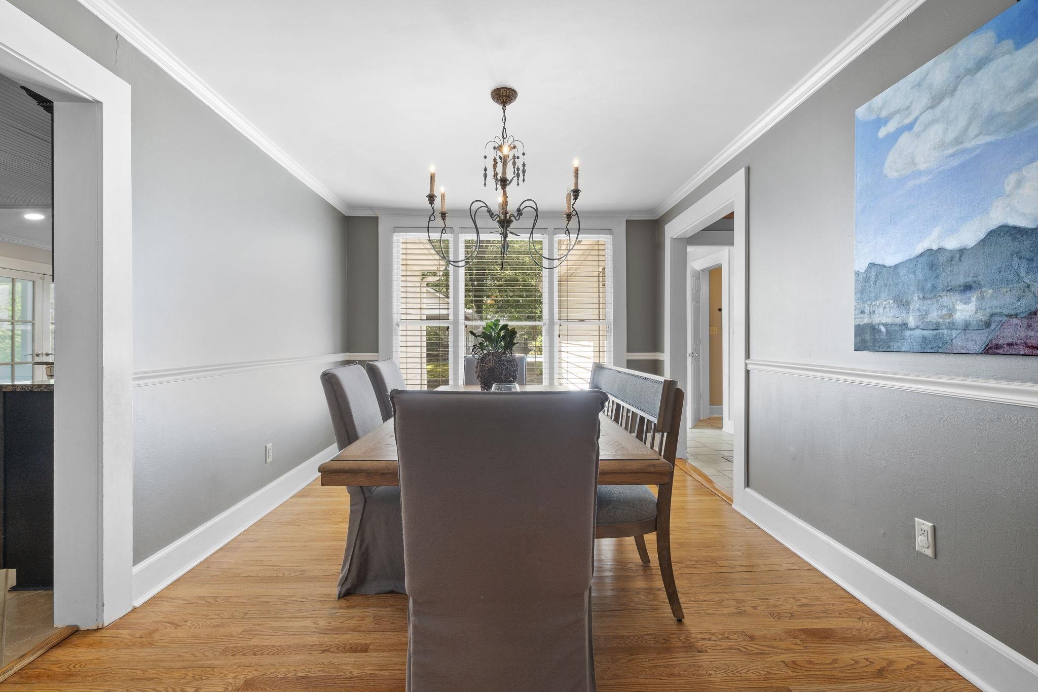 549 Peterson Lake Road Collierville, TN 38017 - Photo 6 of 34 a dining room with wooden floor a chandelier a glass table and chairs