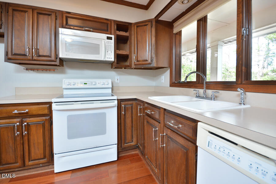 401 Martindale Drive Raleigh, NC 27614 - Photo 12 of 35 a kitchen with stainless steel appliances granite countertop a sink a stove and cabinets