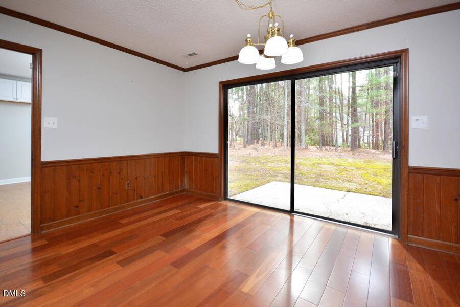 401 Martindale Drive Raleigh, NC 27614 - Photo 16 of 35 a view of an empty room with wooden floor and a window