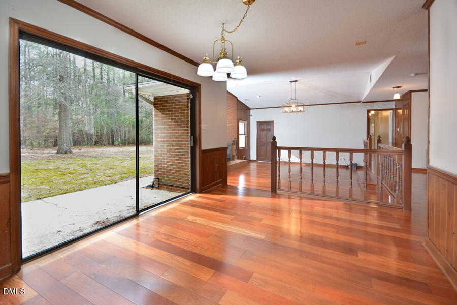 401 Martindale Drive Raleigh, NC 27614 - Photo 17 of 35 a view of an empty room with wooden floor and a window