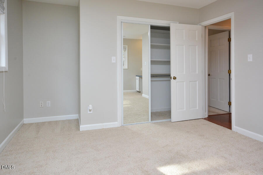 401 Martindale Drive Raleigh, NC 27614 - Photo 24 of 35 a view of an empty room with closet and wooden door