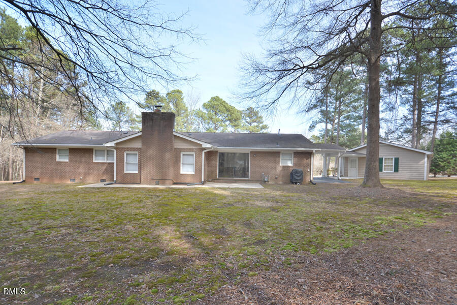401 Martindale Drive Raleigh, NC 27614 - Photo 31 of 35 a front view of a house with a garden and trees