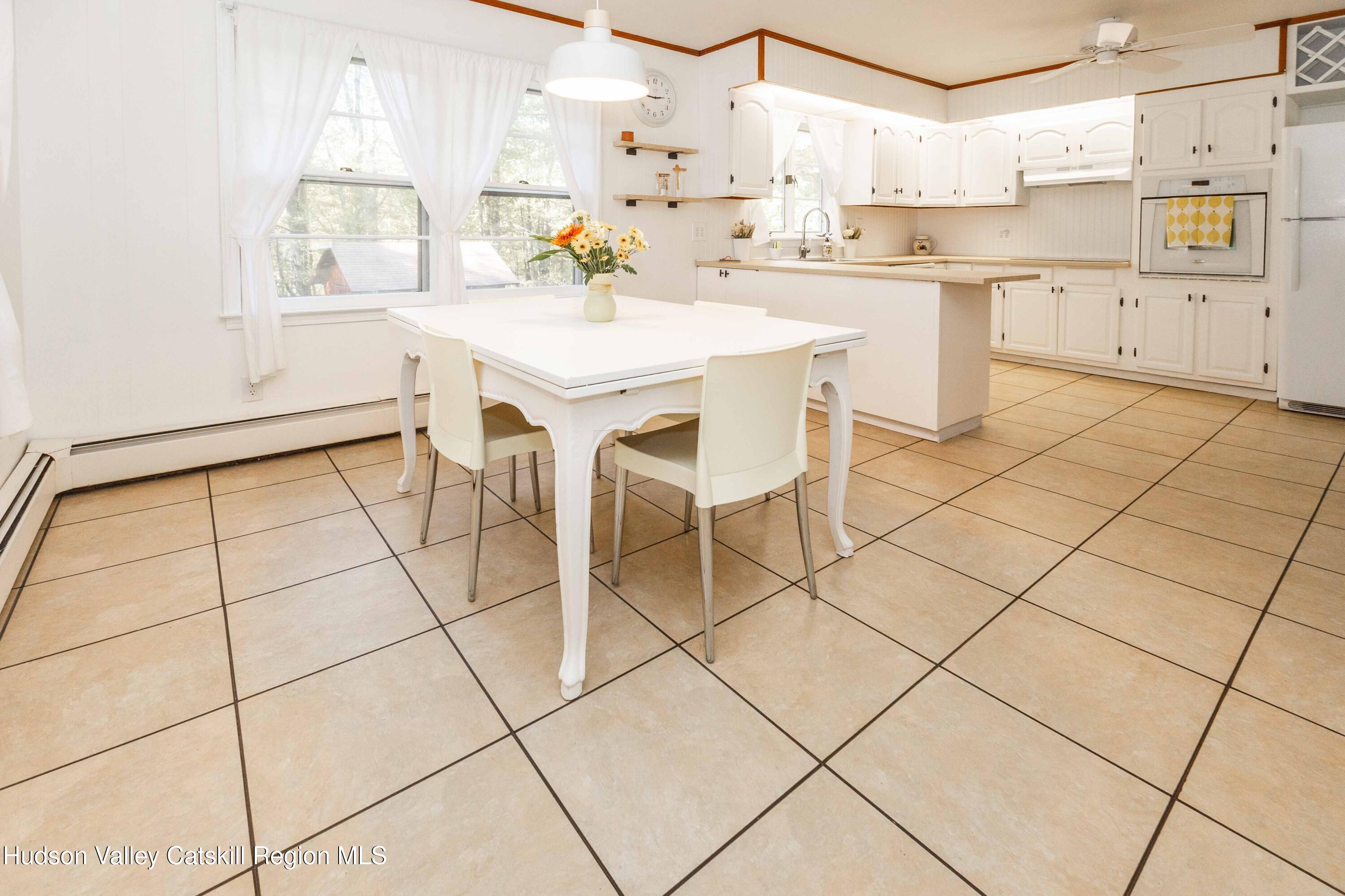 94 Lodge Road Saugerties, NY 12477 - Photo 15 of 46 a kitchen with a sink a stove a table and chairs