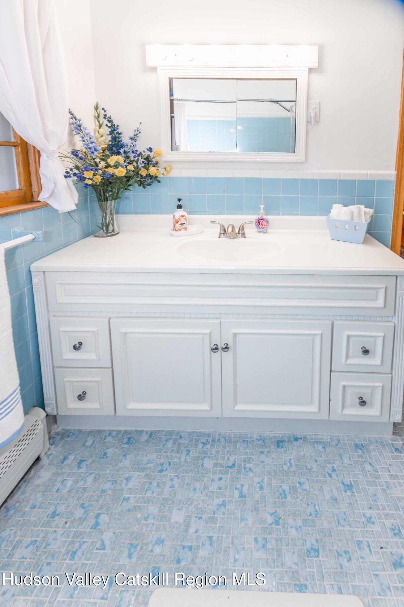 94 Lodge Road Saugerties, NY 12477 - Photo 24 of 46 a bathroom with a sink and a mirror