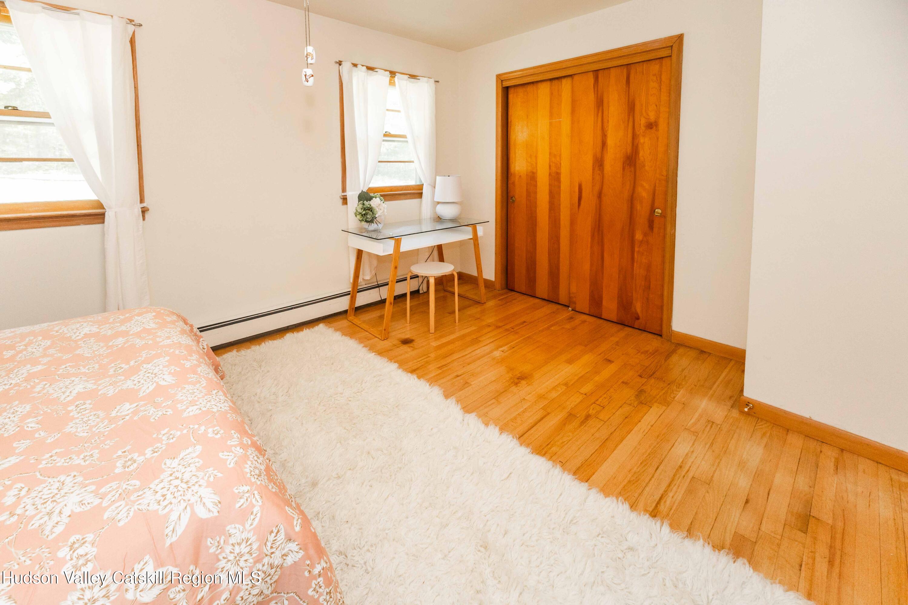 94 Lodge Road Saugerties, NY 12477 - Photo 31 of 46 a view of a bedroom with a bed and chair