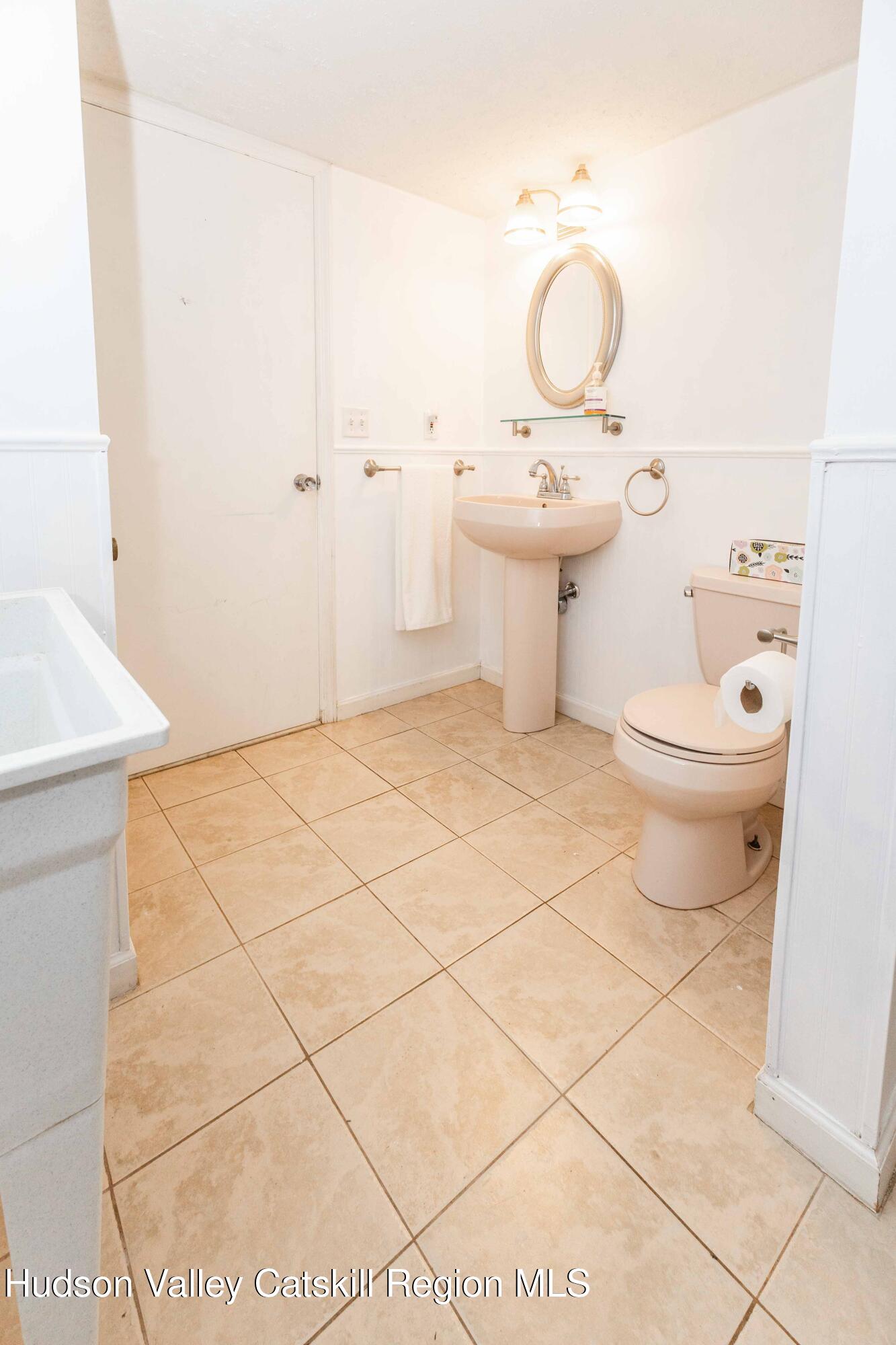 94 Lodge Road Saugerties, NY 12477 - Photo 43 of 47 a bathroom with a toilet a sink and a mirror