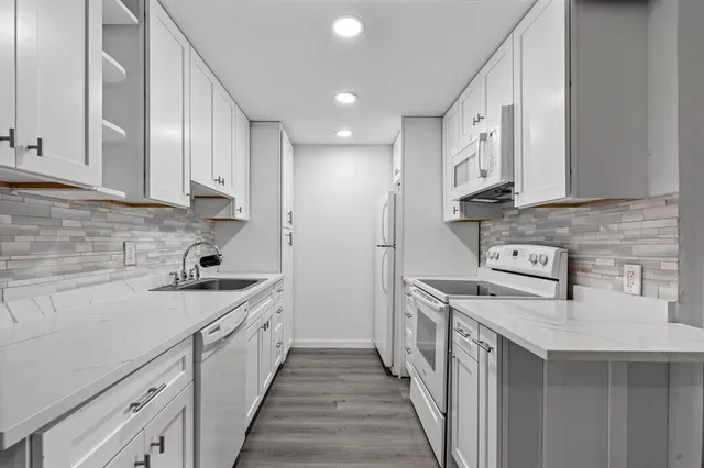 a kitchen with a sink stove and cabinets