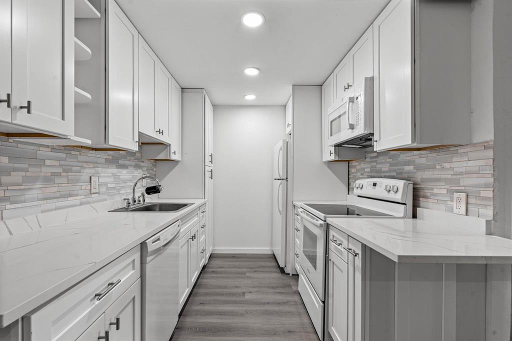 a kitchen with a sink stove and cabinets