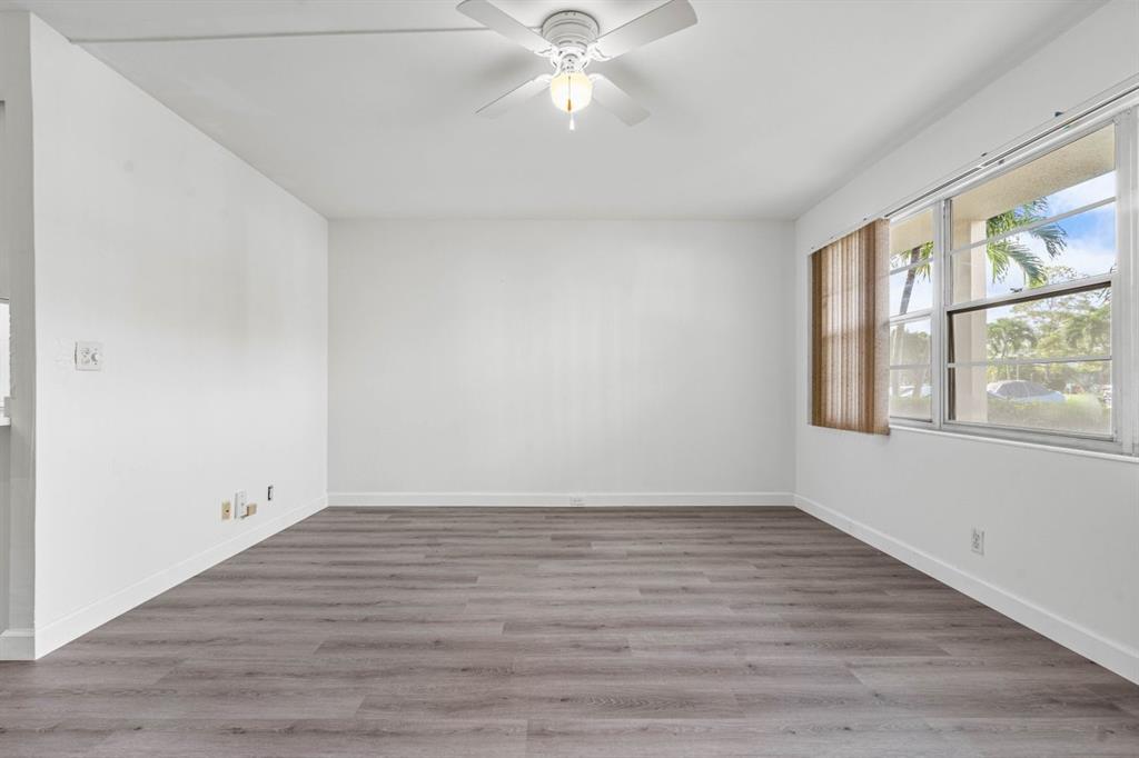 1038 Cambridge B, Unit 1038 Deerfield Beach, FL 33442 - Photo 11 of 22 wooden floor in an empty room with a window