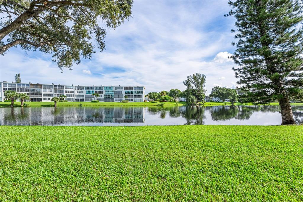 1038 Cambridge B, Unit 1038 Deerfield Beach, FL 33442 - Photo 21 of 22 a view of a lake with a big yard
