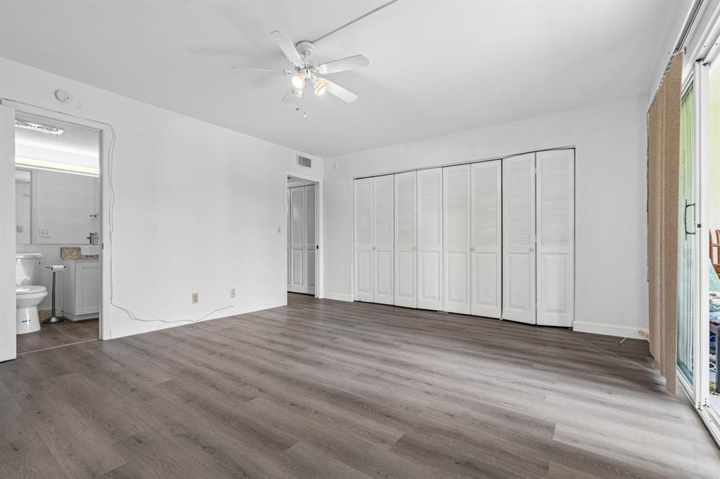 1038 Cambridge B, Unit 1038 Deerfield Beach, FL 33442 - Photo 9 of 22 a view of an empty room with wooden floor
