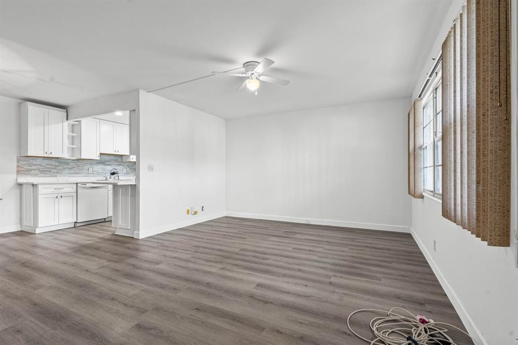 1038 Cambridge B, Unit 1038 Deerfield Beach, FL 33442 - Photo 10 of 22 a view of a kitchen with wooden floor and a ceiling fan