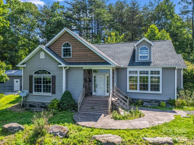 a front view of a house with a yard garage and outdoor seating