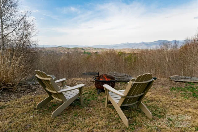 a view of a lake with a bench and wooden floor