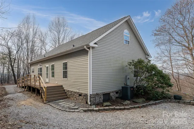 a view of a house with a yard and large tree