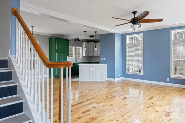 a view of entryway and hall with wooden floor
