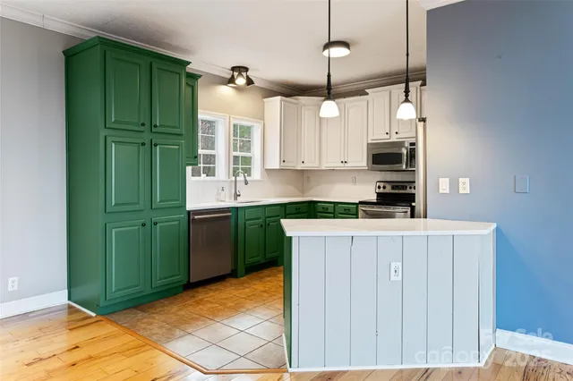 a kitchen with cabinets and a stove top oven