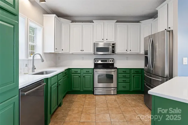 a kitchen with kitchen island a sink stainless steel appliances and cabinets