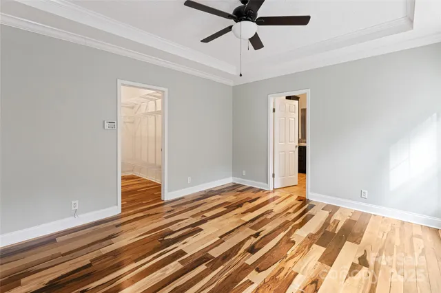 a view of an empty room and wooden floor