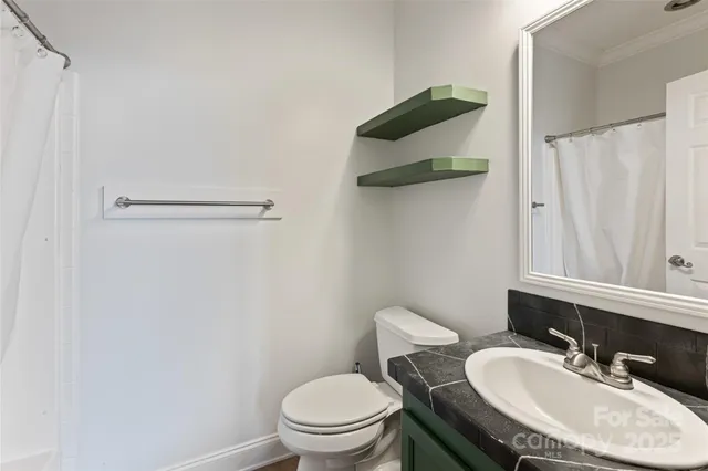 a view of an empty room with closet and windows