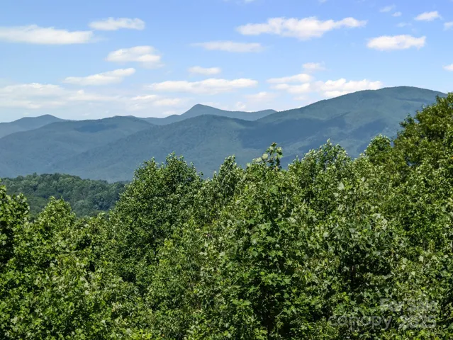 a view of a house with a mountain in the background