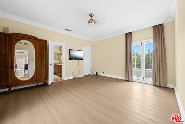 a view of a room with wooden floor and window