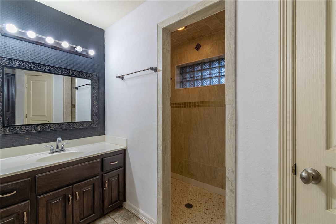 204 County Road 1331 Alice, TX 78332 - Photo 15 of 30 a bathroom with a double vanity sink a mirror and a shower