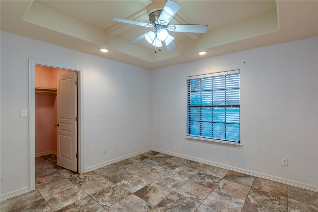 204 County Road 1331 Alice, TX 78332 - Photo 19 of 30 an empty room with windows and ceiling fan