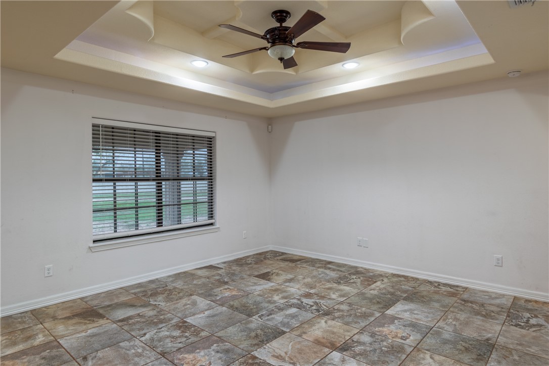 204 County Road 1331 Alice, TX 78332 - Photo 2 of 30 an empty room with chandelier fan and windows