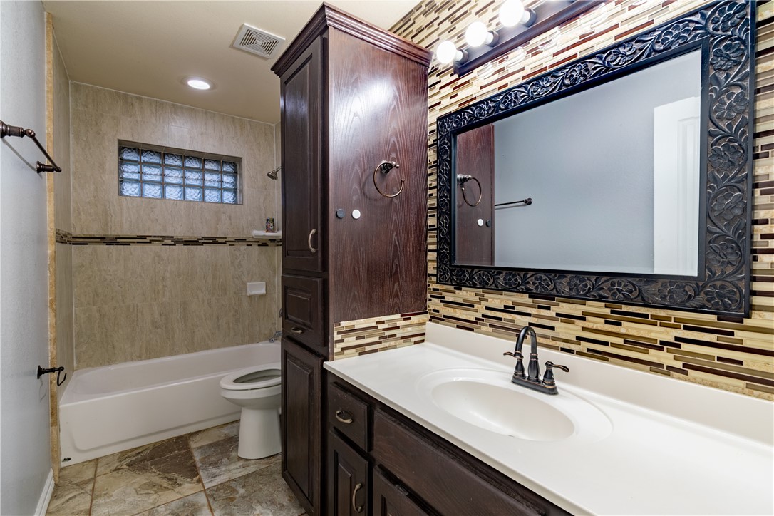 204 County Road 1331 Alice, TX 78332 - Photo 22 of 30 a bathroom with a sink a toilet a mirror and shower