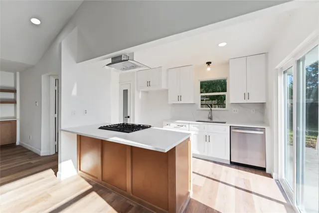 a kitchen with a stove a sink and a refrigerator