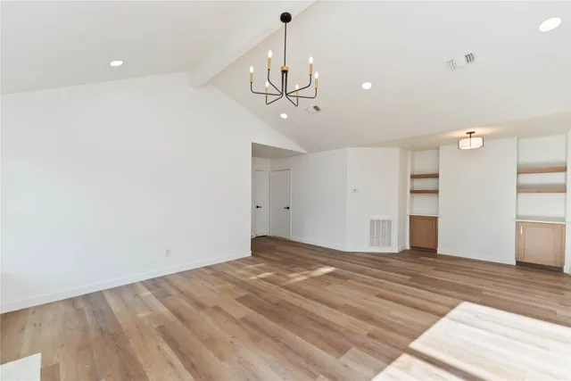 a view of a kitchen with a sink and refrigerator