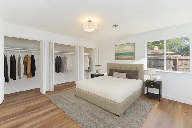 a spacious bedroom with a bed and walk in closet