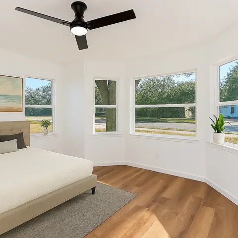 a bedroom with a bed and a window