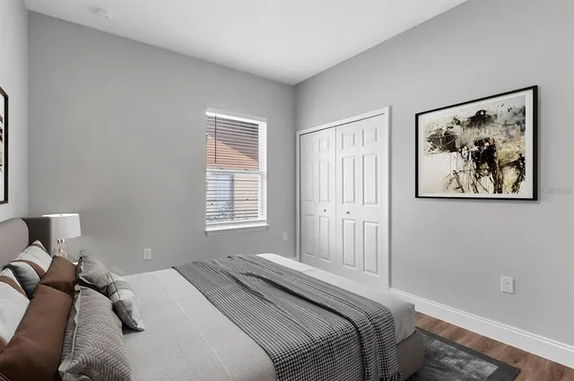 a bedroom with a bed and a painting on the wall