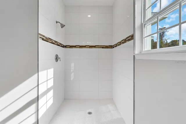 a bathroom with a glass shower door