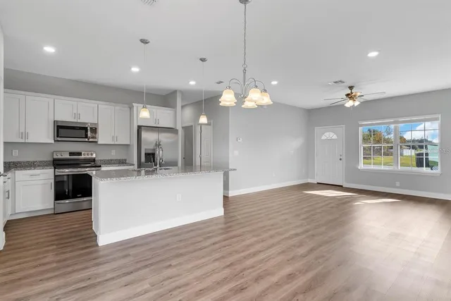 a view of kitchen with sink and wooden floor