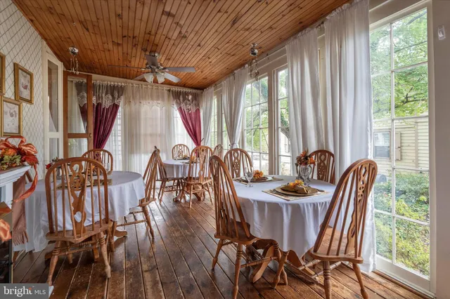a bedroom with a bed next to a window and a flat tv screen
